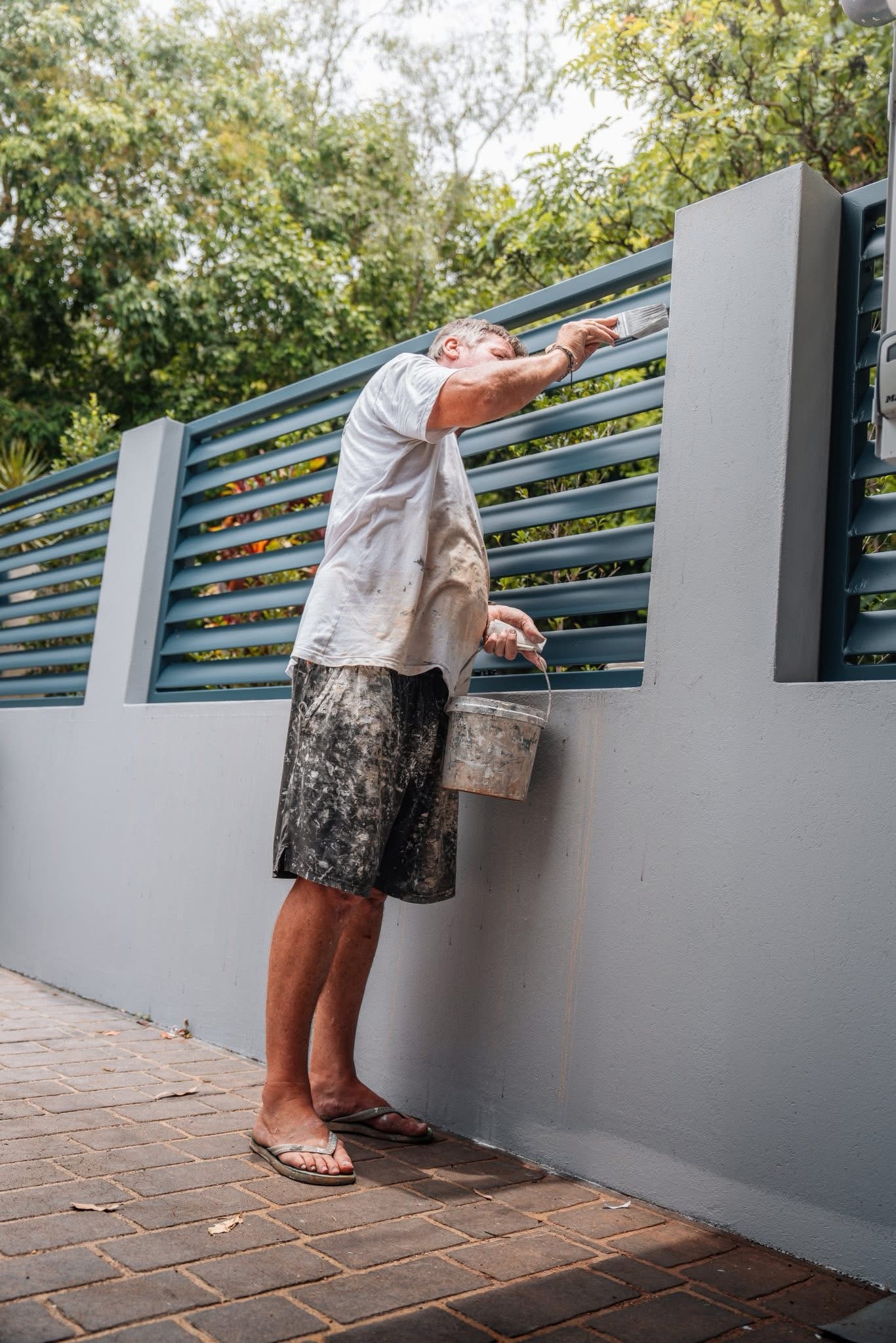 Painter working on residential window frame